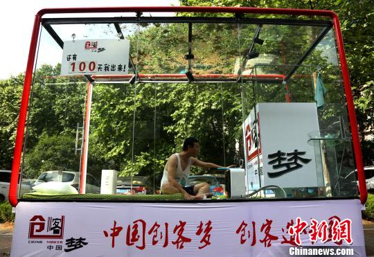 图为创业者安鸿先生在透明玻璃房子里用手机直播自己24小时生活。 张畅 摄