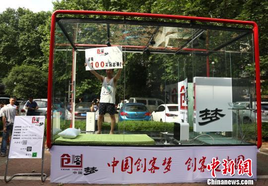 图为创业者安鸿先生在透明玻璃房子里用手机直播自己24小时生活。 张畅 摄