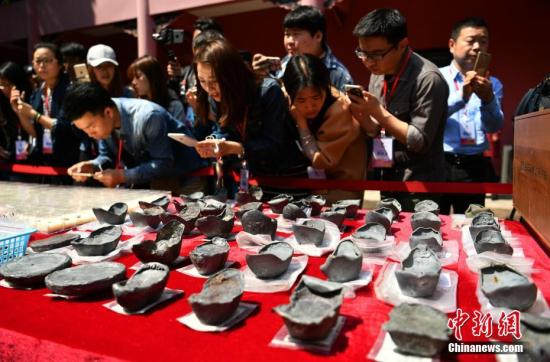 图为民众围观考古发掘出的文物。 刘忠俊 摄