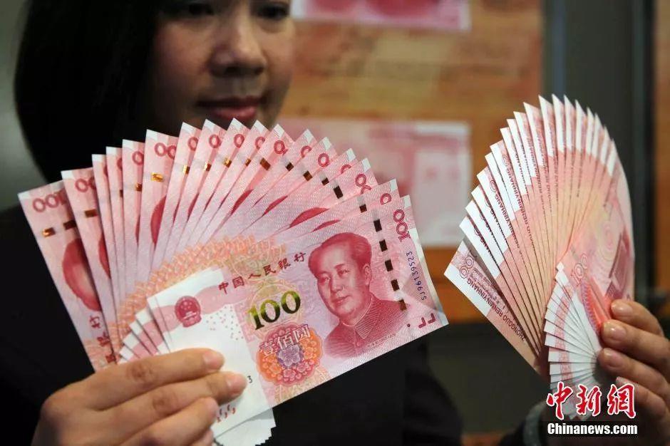 资料图:香港中国银行展示2015年新版第五套100元人民币钞票,中银预料