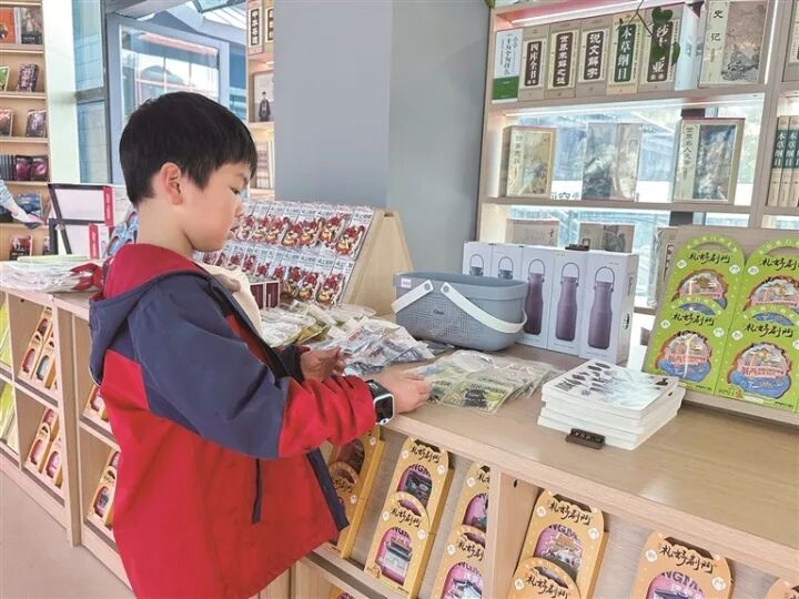 图为小朋友在民主街历史文化街区漫读空间书店选购文创冰箱贴。徐泓杰 摄 图为小朋友在民主街历史文化街区漫读空间书店选购文创冰箱贴。徐泓杰 摄
