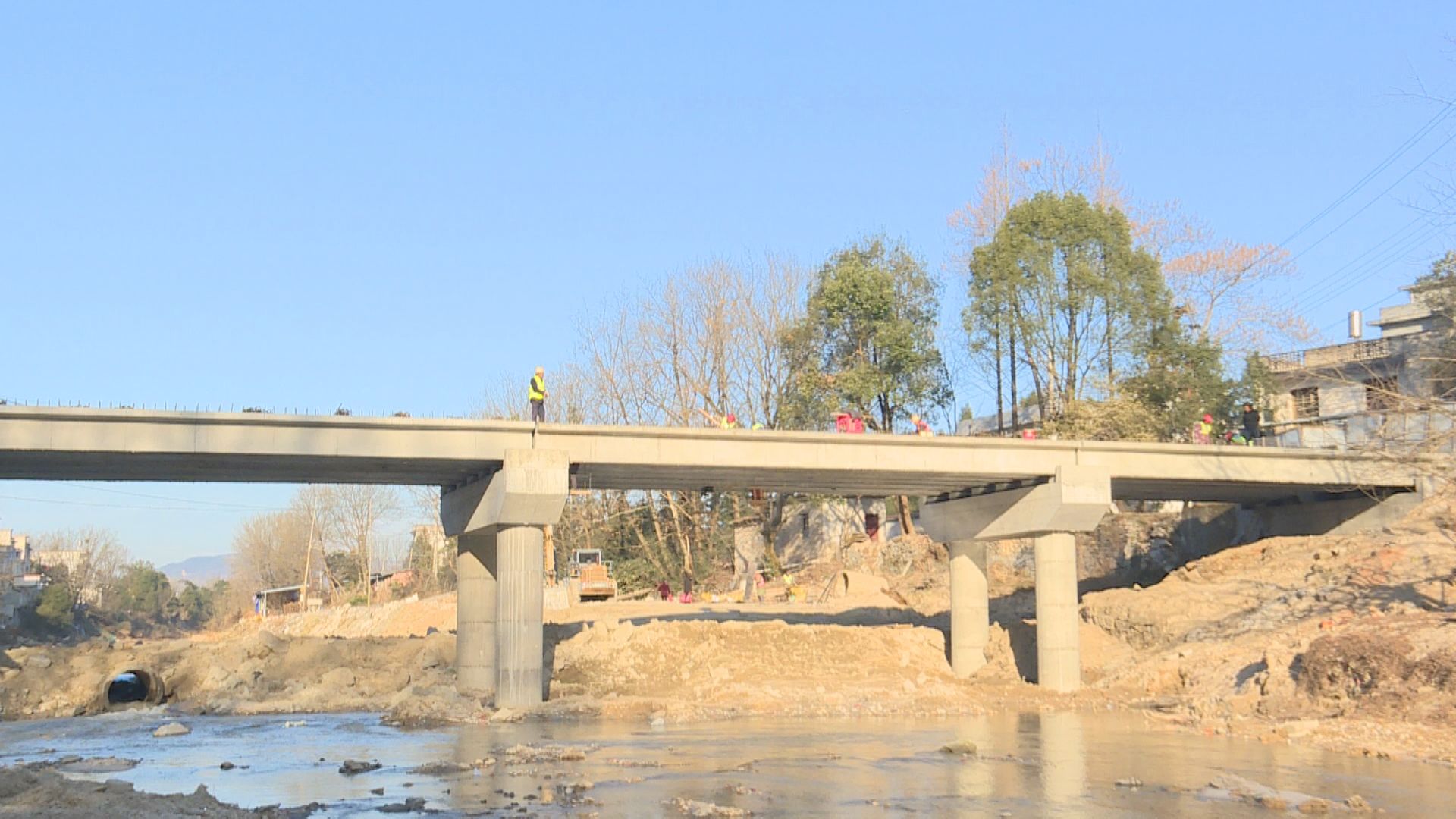 在石南镇弯曲桥施工现场,记者看到,该桥主体结构已横跨两岸,十几名