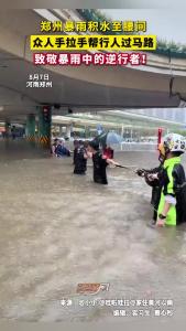 郑州暴雨积水至腰间 众人手拉手行人过马路